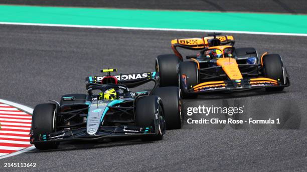 Lewis Hamilton of Great Britain driving the Mercedes AMG Petronas F1 Team W15 leads Oscar Piastri of Australia driving the McLaren MCL38 Mercedes...