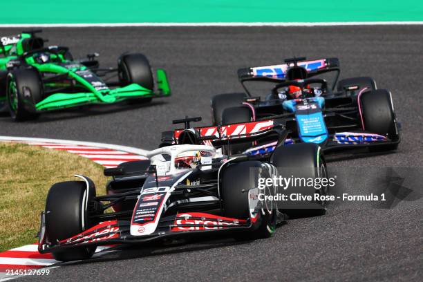 Kevin Magnussen of Denmark driving the Haas F1 VF-24 Ferrari leads Esteban Ocon of France driving the Alpine F1 A524 Renault during the F1 Grand Prix...