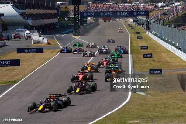 Max Verstappen of the Netherlands driving the Oracle Red Bull Racing RB20 leads Sergio Perez of Mexico driving the Oracle Red Bull Racing RB20 and...