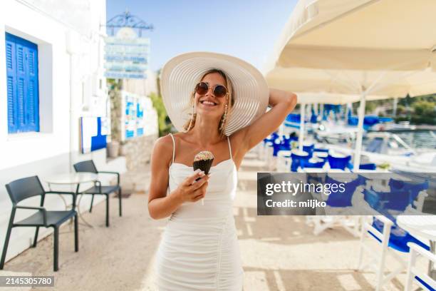 enjoying morning with refreshing ice cream on seaside - greek style stock pictures, royalty-free photos & images