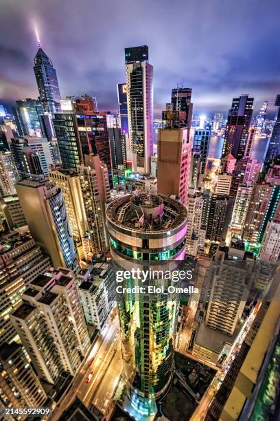 aerial view of wan chai district, central hong kong at night - harbor east stock pictures, royalty-free photos & images