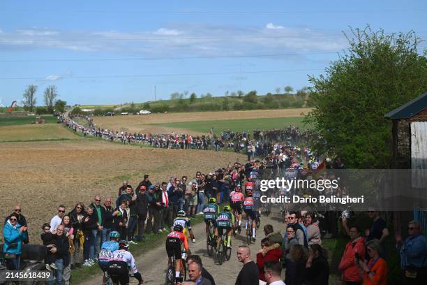 Alvaro Jose Hodeg of Colombia and UAE Team Emirates, Lars Craps of Belgium and Team Flanders - Baloise and a general view of the peloton passing...