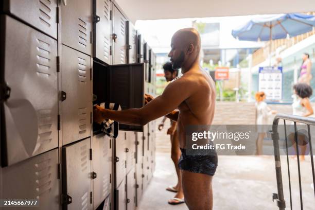 Using Locker Mid Adult Man Using Locker At Resort Locker Room High-Res Stock Photo ...