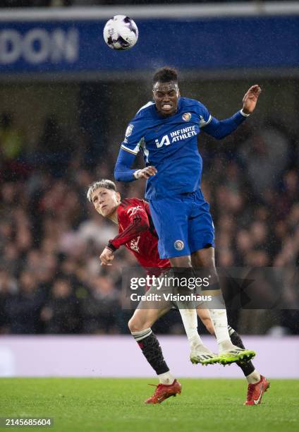 Benoit Badiashile of Chelsea outjumps Alejandro Garnacho of Manchester United during the Premier League match between Chelsea FC and Manchester...