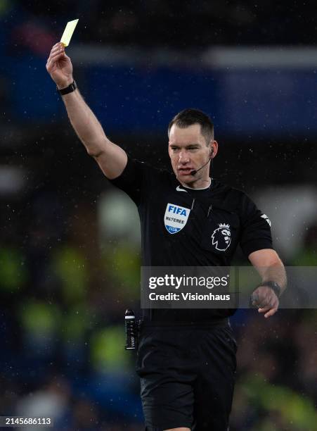 Referee Jarred Gillett issues a yellow card during the Premier League match between Chelsea FC and Manchester United at Stamford Bridge on April 04,...