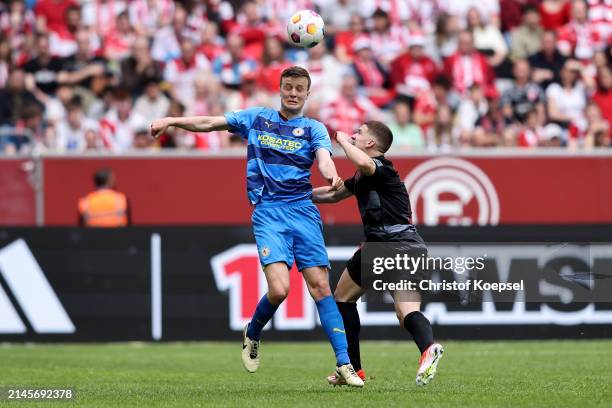 Robert Ivanov of Braunschweig and Christos Tzolis of Düsseldorf go up for a header during the Second Bundesliga match between Fortuna Düsseldorf and...