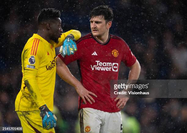 Andre Onana and Harry Maguire of Manchester United react to the awarding of Chelsea's second penalty during the Premier League match between Chelsea...