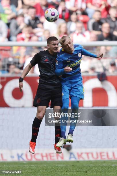 Christos Tzolis of Düsseldorf and Saulo Decarli of Braunschweig go up for a header during the Second Bundesliga match between Fortuna Düsseldorf and...
