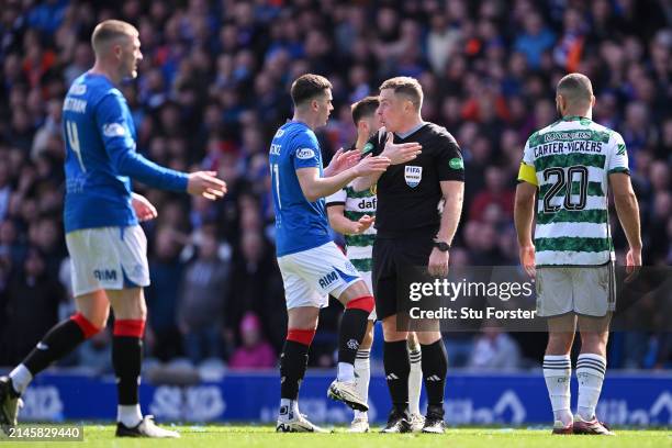 Referee John Beaton speaks to Tom Lawrence of Rangers during the Cinch Scottish Premiership match between Rangers FC and Celtic FC at Ibrox Stadium...