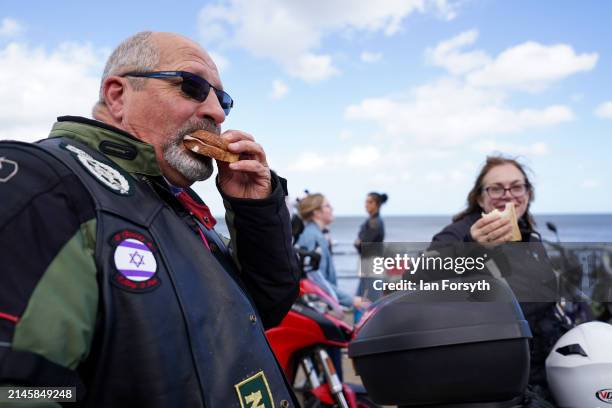 Bikers eat sandwiches on the seafront as they arrive in Scarborough after completing a memorial bike ride for Dave Myers of the Hairy Bikers on April...