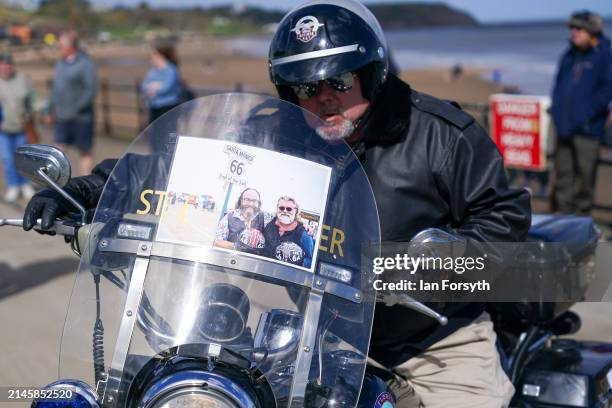 Biker parks his Harley Davidson motorcycle on the seafront as he arrives in Scarborough after completing a memorial bike ride for Dave Myers of the...
