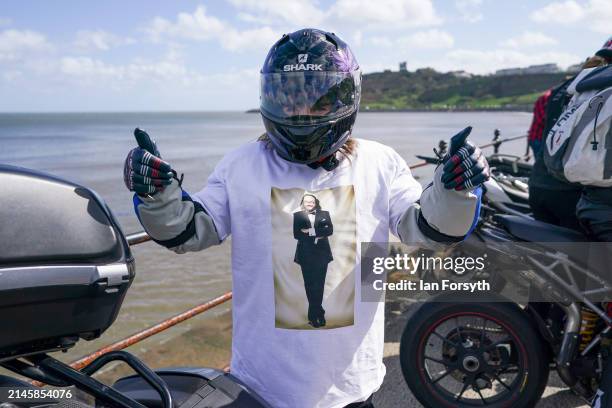 Biker reacts to the camera as she parks her bike after completing a memorial bike ride for Dave Myers of the Hairy Bikers on April 07, 2024 in...