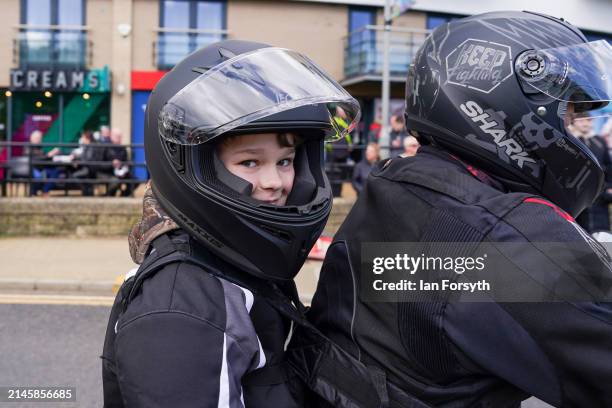 Young passenger reacts as bikers arrive in Scarborough after completing a memorial bike ride for Dave Myers of the Hairy Bikers on April 07, 2024 in...
