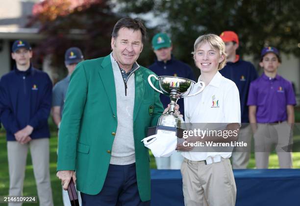 Connor Holden, first overall, of the Boy's 14-15 group poses with Sir Nick Faldo of England during the Drive, Chip and Putt Championship at Augusta...