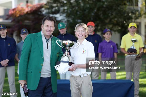Connor Holden, first overall, of the Boy's 14-15 group poses with Sir Nick Faldo of England during the Drive, Chip and Putt Championship at Augusta...
