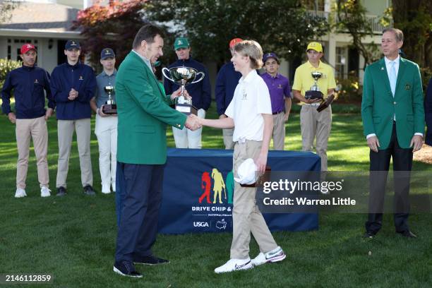 Connor Holden, first overall, of the Boy's 14-15 group shakes hands with Sir Nick Faldo of England during the Drive, Chip and Putt Championship at...