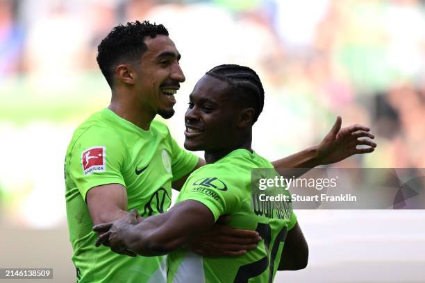 Ridle Baku of VfL Wolfsburg celebrates scoring his team's first goal with teammate Tiago Tomas during the Bundesliga match between VfL Wolfsburg and...