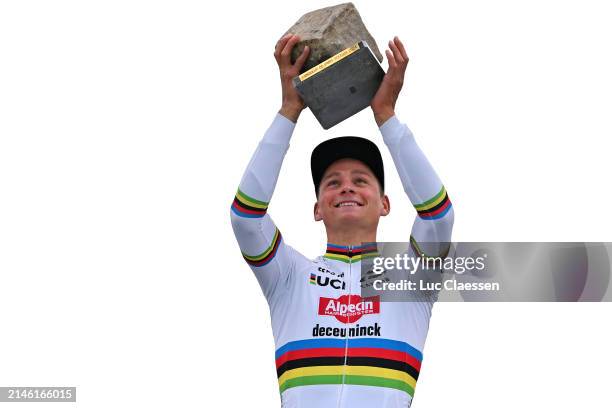 Mathieu van der Poel of The Netherlands and Team Alpecin - Deceuninck celebrates at podium as race winner with the Cobblestone Trophy during the...