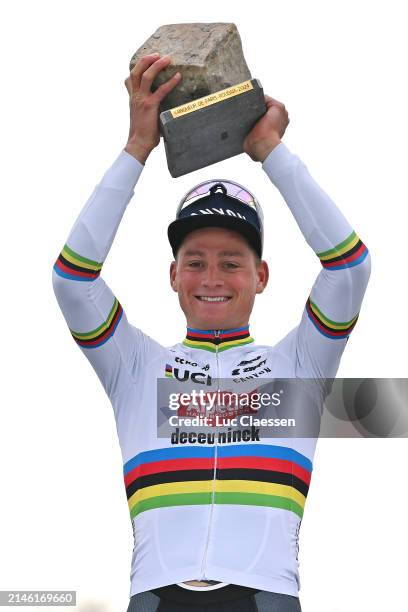 Mathieu van der Poel of The Netherlands and Team Alpecin - Deceuninck celebrates at podium as race winner with the Cobblestone Trophy during the...