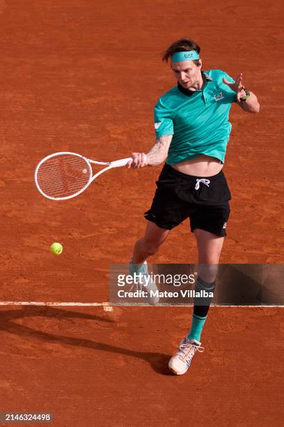 Alexander Bublik of Kazakhstan returns the ball against Borna Coric of Croatia in their Men's Singles Round of 64 match during day one of the Rolex...