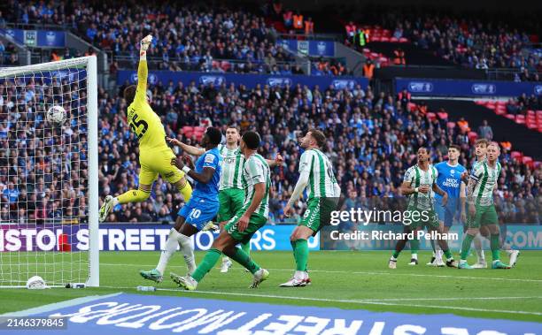 Harrison Burrows of Peterborough United scores his team's second goal past Franco Ravizzoli of Wycombe Wanderers during the Bristol Street Motors...