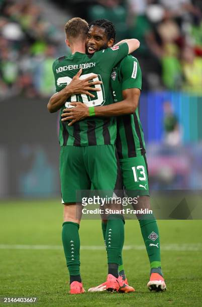 Jordan Siebatcheu and Nico Elvedi of Borussia Mönchengladbach celebrate following the team's victory in the Bundesliga match between VfL Wolfsburg...