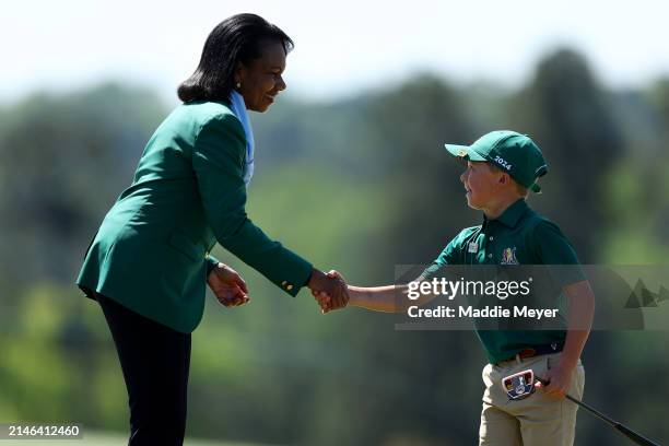 Berck Phipps of the Boy's 7-9 group shakes hands with Former United States Secretary of State Condoleezza Rice during the Drive, Chip and Putt...