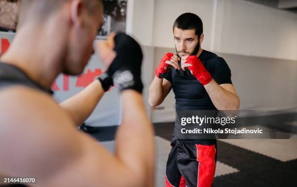 two mma fighters training in a gym - protective sportswear stock pictures, royalty-free photos & images