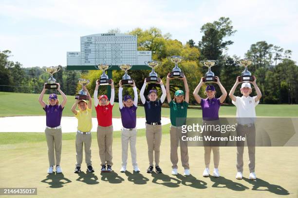 The champions pose with their trophies after the Drive, Chip and Putt Championship at Augusta National Golf Club at Augusta National Golf Club on...