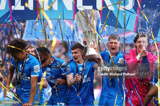 Harrison Burrows and Josh Knight of Peterborough United lift the Bristol Street Motors Trophy after the team's victory during the Bristol Street...