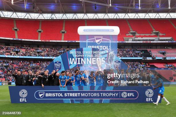 Harrison Burrows and Josh Knight of Peterborough United lift the Bristol Street Motors Trophy after the team's victory during the Bristol Street...