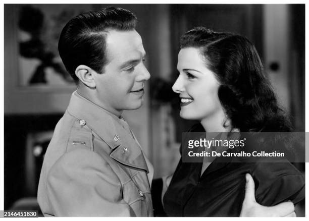 Publicity portrait of South African actor Louis Hayward (as 'Lt. Jim Cameron' and American actor Jane Russell in the film 'Young Widow' United States.