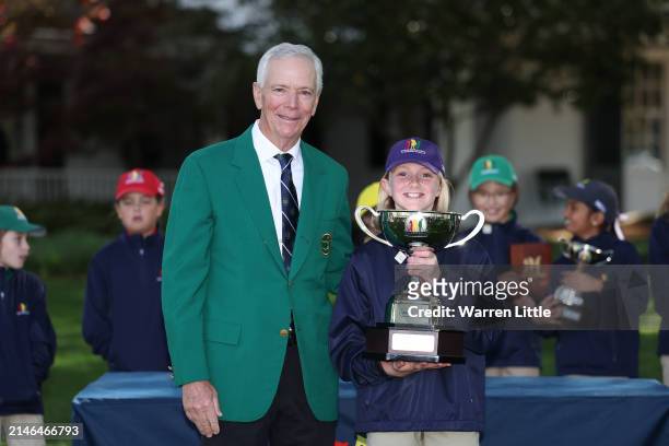 Madison Pyatt first overall in the Girl's 7-9 group poses with Larry Mize during the Drive, Chip and Putt Championship at Augusta National Golf Club...
