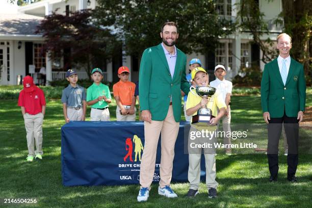 Parker Tang, first place overall in the Boy's 7-9 group, poses with Scottie Scheffler of the United States during the Drive, Chip and Putt...