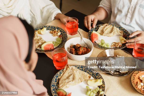 close-up shot of hands holding food. - iftar stock pictures, royalty-free photos & images