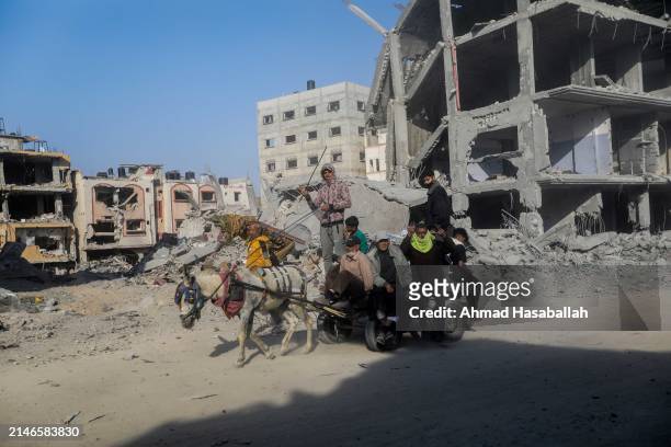 People inspect damage and remove items from their homes following Israeli airstrikes on April 07, 2024 in Khan Yunis, Gaza. The Israeli military...