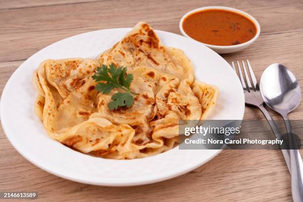 close up of roti canai and curry dipping sauce - roti canai stock pictures, royalty-free photos & images