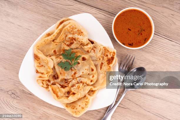 high angle view of roti canai and curry dipping sauce - roti canai stock pictures, royalty-free photos & images