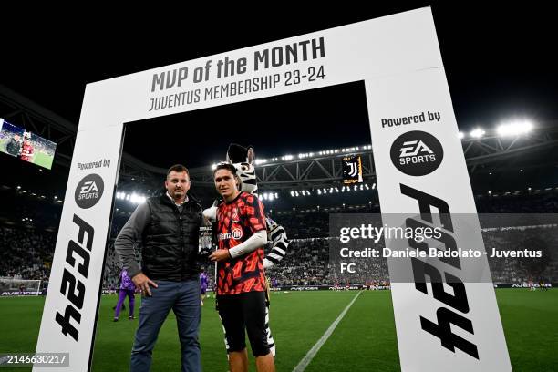 Federico Chiesa of Juventus poses for a picture with his MVP trophy togheter a fan prior the Serie A TIM match between Juventus and ACF Fiorentina at...