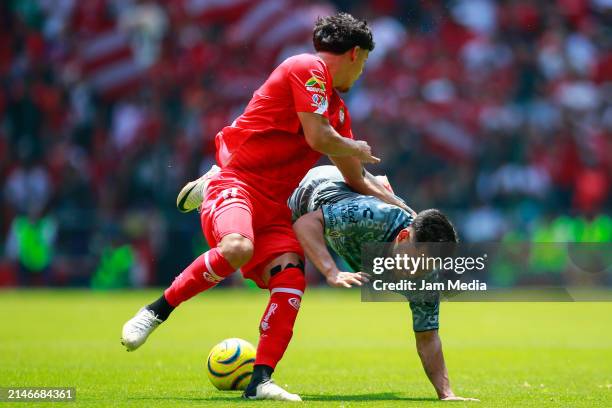 Maximiliano Araujo of Toluca fights for the ball with Eduardo Aguirre of Atlas during the 14th round match between Toluca and Atlas as part of the...