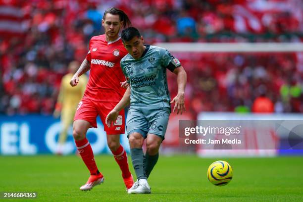 Jesus Angulo of Toluca fights for the ball with Edgar Zaldivar of Atlas during the 14th round match between Toluca and Atlas as part of the Torneo...