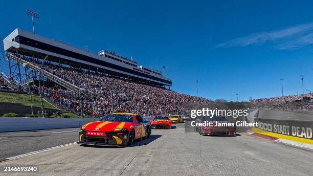 Bubba Wallace, driver of the McDonald's Toyota, and Kyle Larson, driver of the HendrickCars.com Ruby Chevrolet, lead the field on a pace lap prior to...