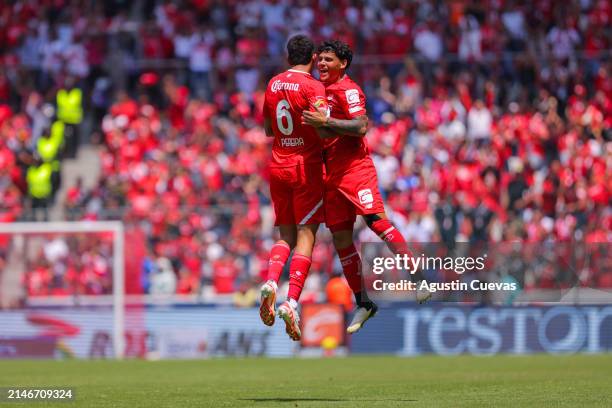 Maximiliano Araujo and Andres Pereira of Toluca celebrate the team's fourth goal scored by teammate Edgar Lopez during the 14th round match between...