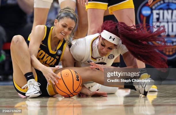 Gabbie Marshall of the Iowa Hawkeyes and Kamilla Cardoso of the South Carolina Gamecocks fight for the ball in the second half during the 2024 NCAA...