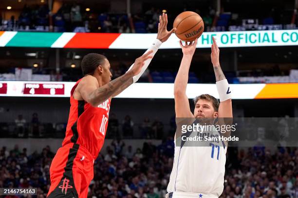 Luka Doncic of the Dallas Mavericks shoots as Jabari Smith Jr. #10 of the Houston Rockets defends during the first half at American Airlines Center...