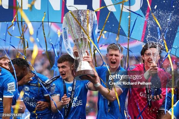 Harrison Burrows and Josh Knight of Peterborough United lift the Bristol Street Motors Trophy after the team's victory during the Bristol Street...