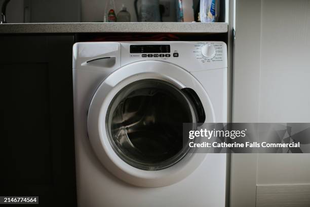 simple image of a modern washing machine - washing machine front stock pictures, royalty-free photos & images