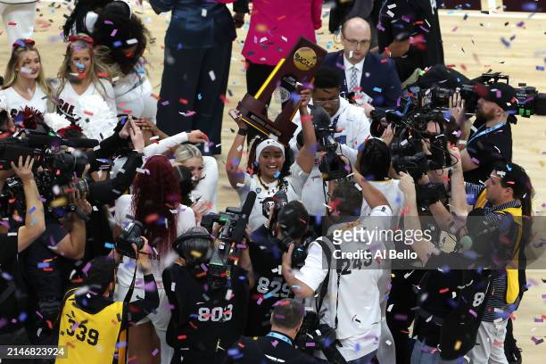 Te-Hina Paopao of the South Carolina Gamecocks hoists the trophy after beating the Iowa Hawkeyes in the 2024 NCAA Women's Basketball Tournament...