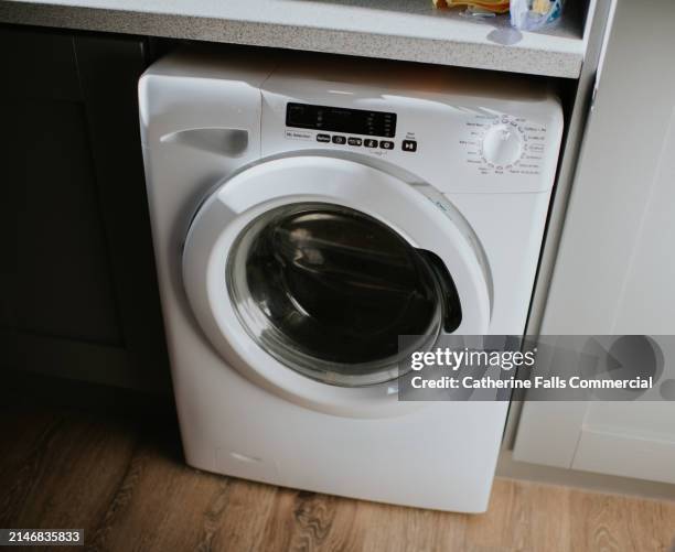 simple image of a modern washing machine - washing machine front stock pictures, royalty-free photos & images