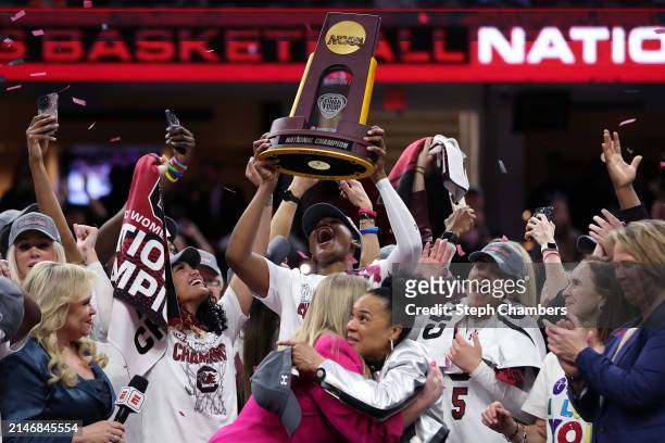 The South Carolina Gamecocks celebrate with the trophy after beating the Iowa Hawkeyes in the 2024 NCAA Women's Basketball Tournament National...